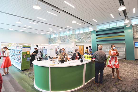 Librarians and patrons standing at the counter in the John's Island library.