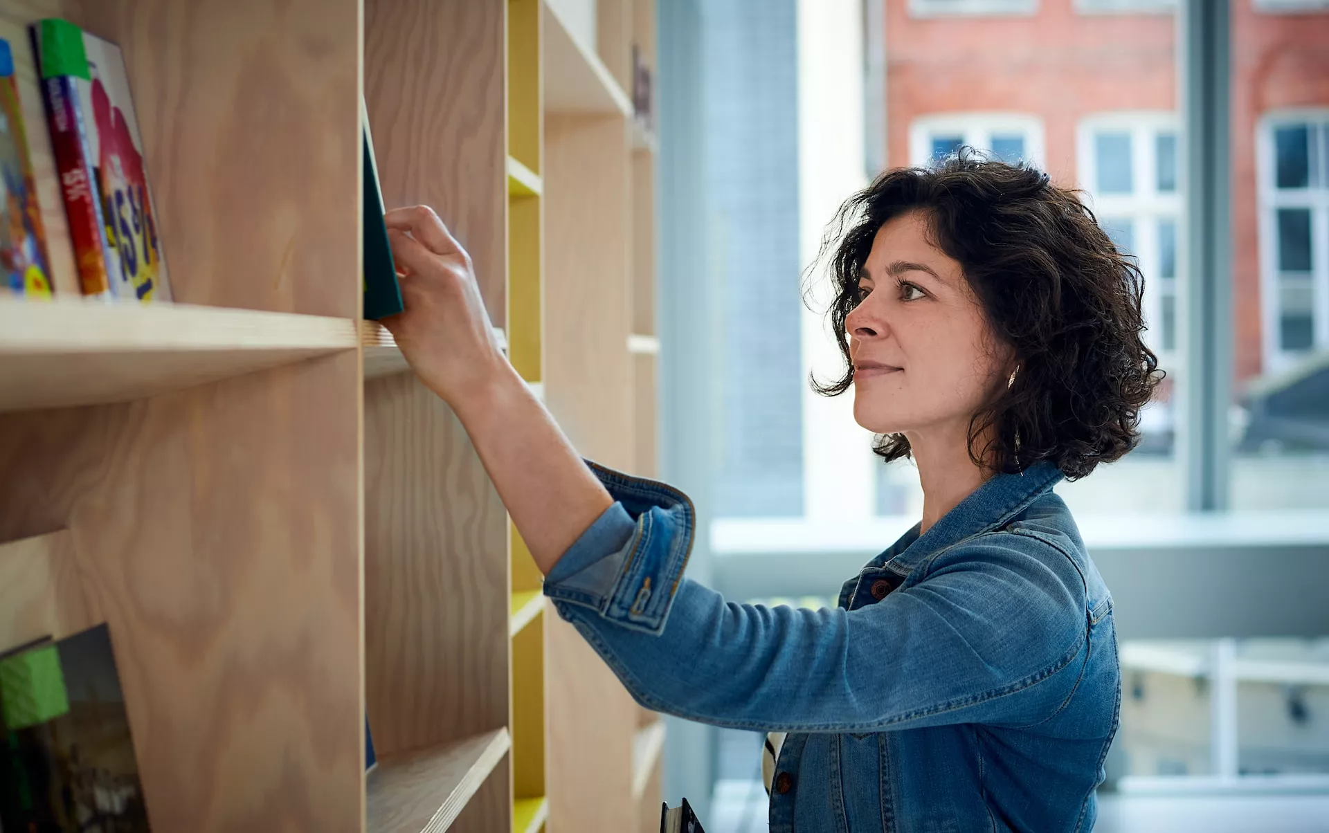 librarian getting book from shelf
